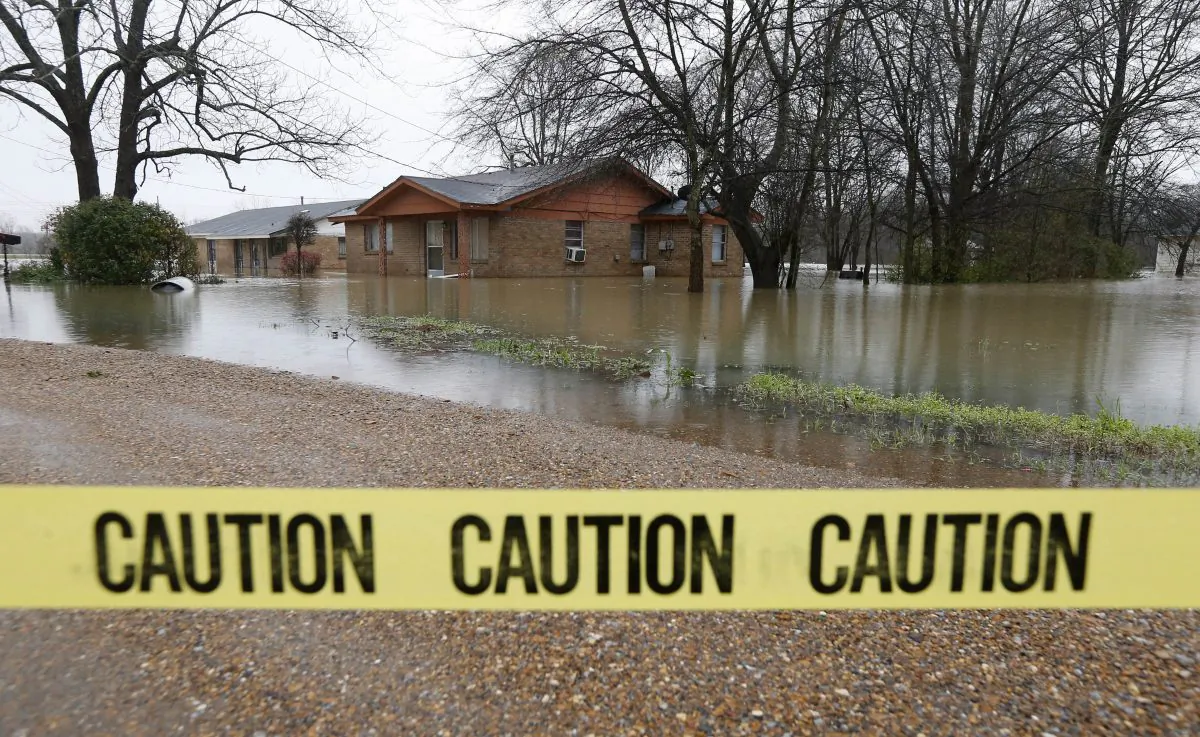 Caution tape closes off this neighborhood in Drew, Miss., on March 11, 2016, as floodwaters have affected areas in the Delta. The flooding has affected the Delta to varying degrees. Additional rain is expected to continue through Saturday. (AP Photo/Rogelio V. Solis)