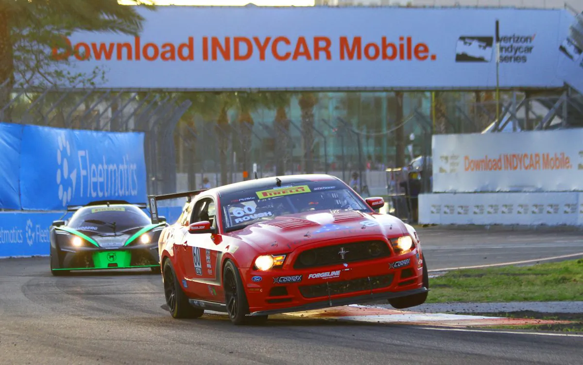 Jack Roush Jr. in the #60 Roush Performance Mustang hits the curb at Turn 11 at St. Petersburg on his way to winning his second Pirelli World Challenge GTS race. (Chris Jasurek/Epoch Times)