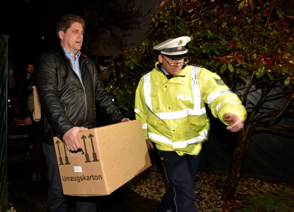 Investigators carry boxes from the apartment of Germanwings airliner jet co-pilot Andreas Lubitz, in Duesseldorf, Germany, Thursday March 26, 2015. On Thursday, French prosecutors said Lubitz, the co-pilot of Germanwings Flight 9525, "intentionally" crashed the jet into the side of a mountain Tuesday in the French Alps. (AP Photo/Martin Meissner)