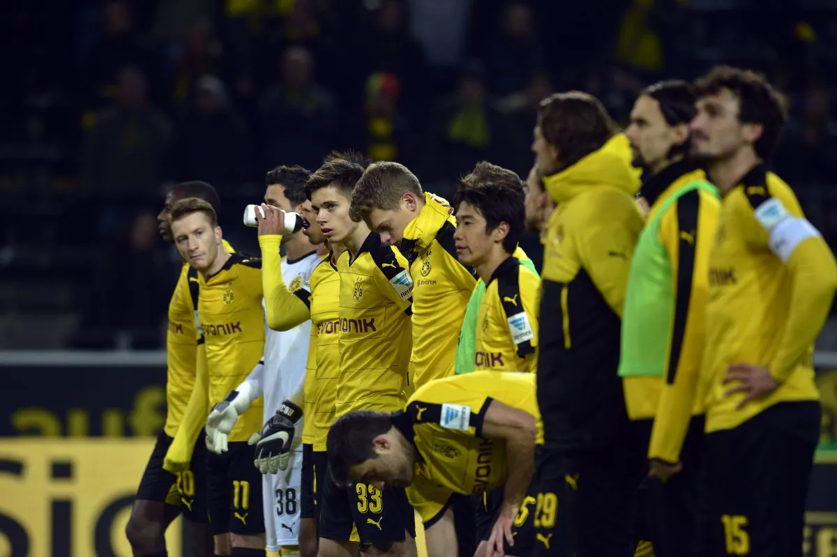 Dormund's players line up to show their respects after the death of a fan during the German first division Bundesliga football match Borussia Dortmund versus Mainz in Dortmund. (Sascha Schuermann/AFP/Getty Images)
