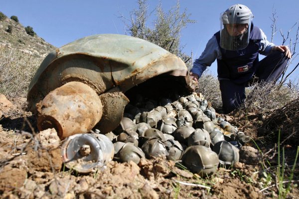 Nick Guest, Mines Advisory Group (MAG) field technical manager, inspects a cluster bomb unit in the southern village of Ouazaiyeh, Lebanon, dropped by Israeli warplanes during the 34-day Hezbollah-Israeli war on November 9, 2006.  (AP Photo/Mohammed Zaatari)