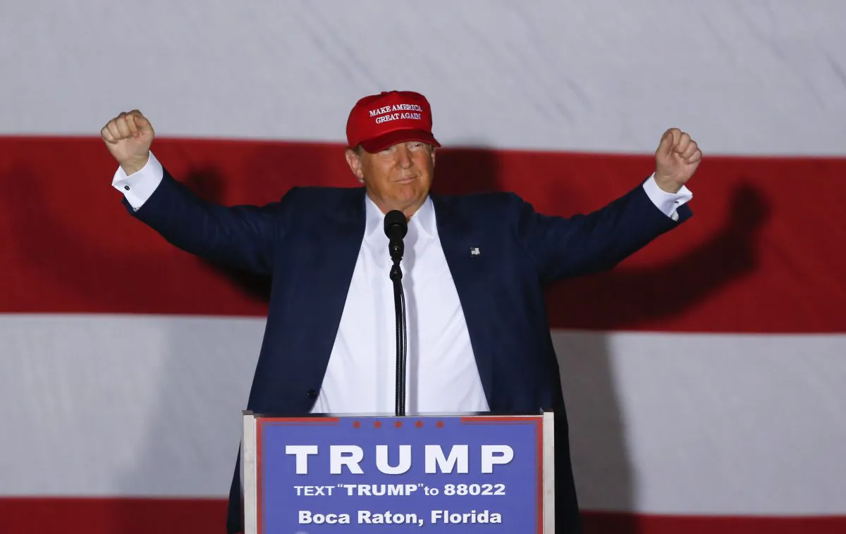 Republican presidential candidate Donald Trump raises his arms during a campaign rally in Boca Raton, Fla., Sunday, March 13, 2016. (AP Photo/Paul Sancya)