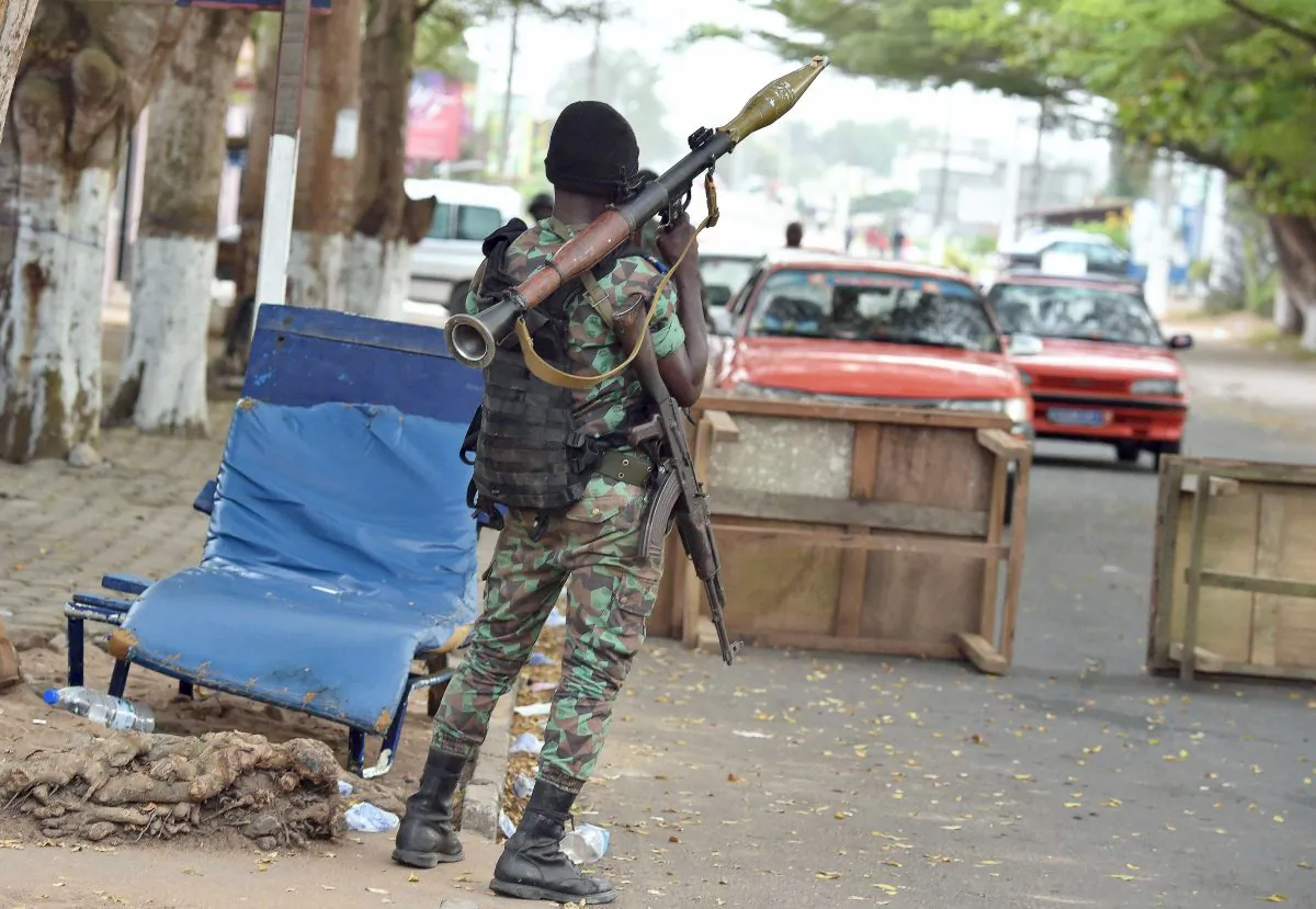 An Ivorian soldier holds a Rocket-propelled grenade while manning a position in a street near the the Etoile du Sud hotel in Grand Bassam on March 14, 2016 a day after heavily armed gunmen opened fire at a hotel in the Ivory Coast beach resort. Gunmen killed 16 people at an Ivory Coast resort on March 13 leaving bodies strewn on the beach, in an attack claimed by an Al-Qaida affiliate as fears grow of a mounting jihadist threat in west Africa. Armed with grenades and assault riffles, the attackers stormed three hotels in the sleepy resort of Grand-Bassam, popular with expats, around 25 miles east of the commercial hub Abidjan. (Issouf Sanogo/AFP/Getty Images)