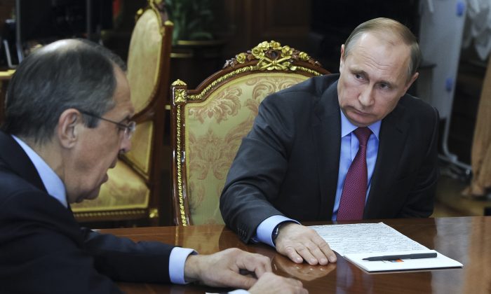 Russian President Vladimir Putin, right, listens to Russian Foreign Minister Sergey Lavrov in a file photo. (Mikhail Klimentyev/Sputnik, Kremlin Pool Photo via AP)