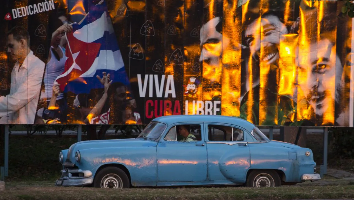 A taxi driving a classic American car passes a billboard that reads in Spanish: "Long live free Cuba" in Havana, Cuba, Monday, March 14, 2016. U.S. President Barack Obama will travel to Cuba on March 20. The trip will mark a watershed moment in U.S.-Cuba relations, making Obama the first sitting U.S. president to set foot on the island in nearly seven decades. (AP Photo/Desmond Boylan)