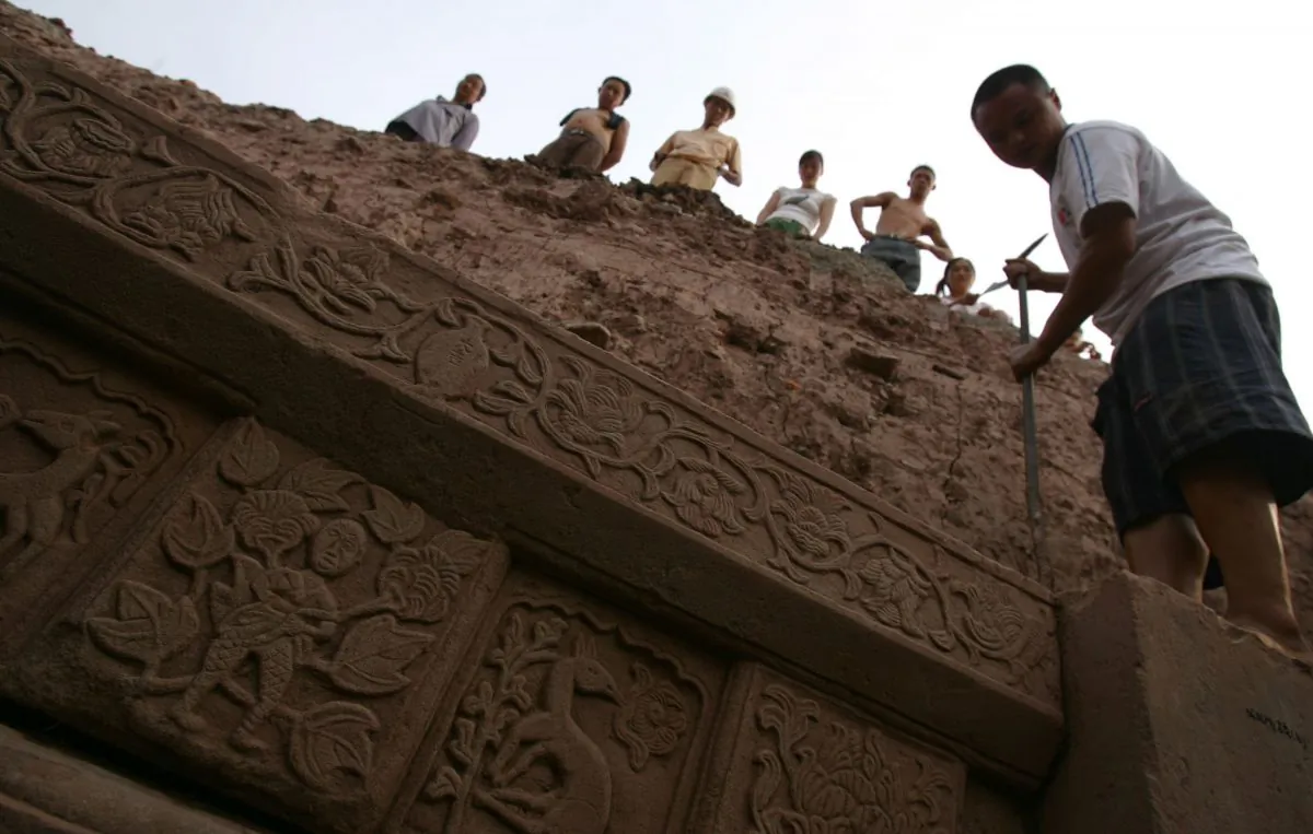 Laborers work on the excavation of a tomb at a construction site at Yubei District in Chongqing on Aug. 28, 2006. (China Photos/Getty Images)
