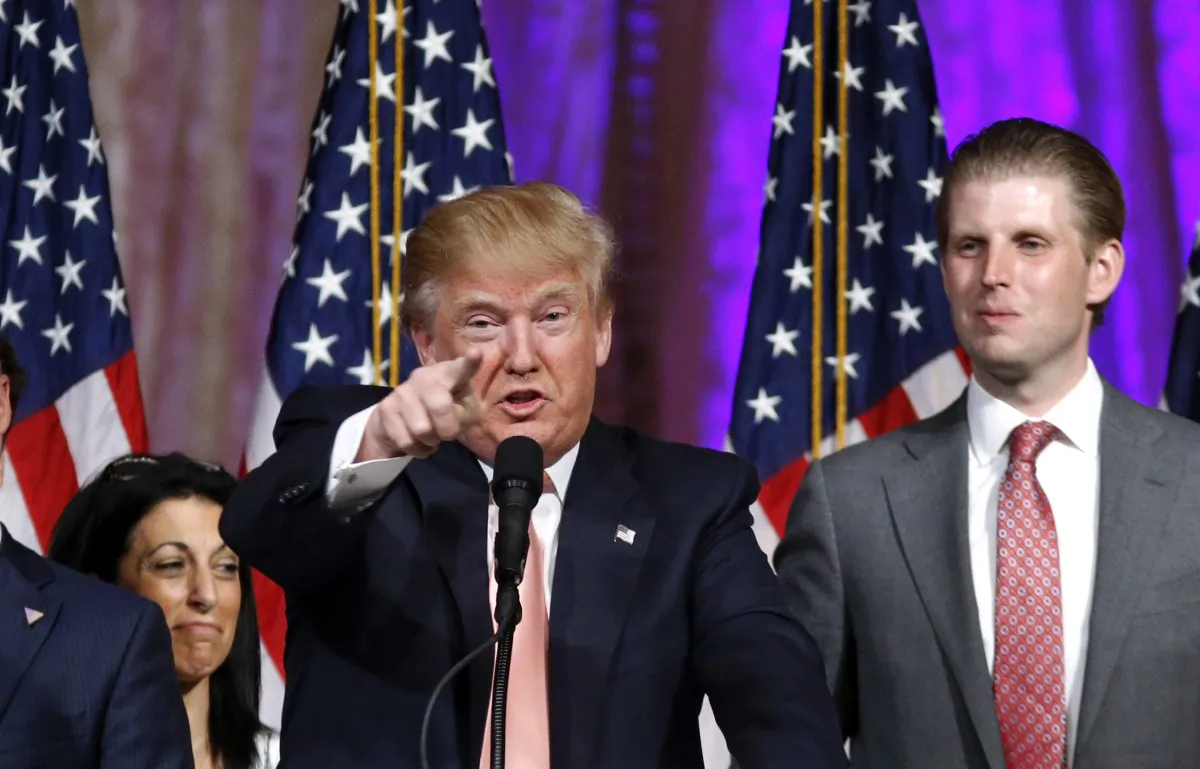 Republican presidential candidate Donald Trump speaks to supporters at his primary election night event at his Mar-a-Lago Club in Palm Beach, Fla., on March 15, 2016. At right is his son Eric Trump. (AP Photo/Gerald Herbert)