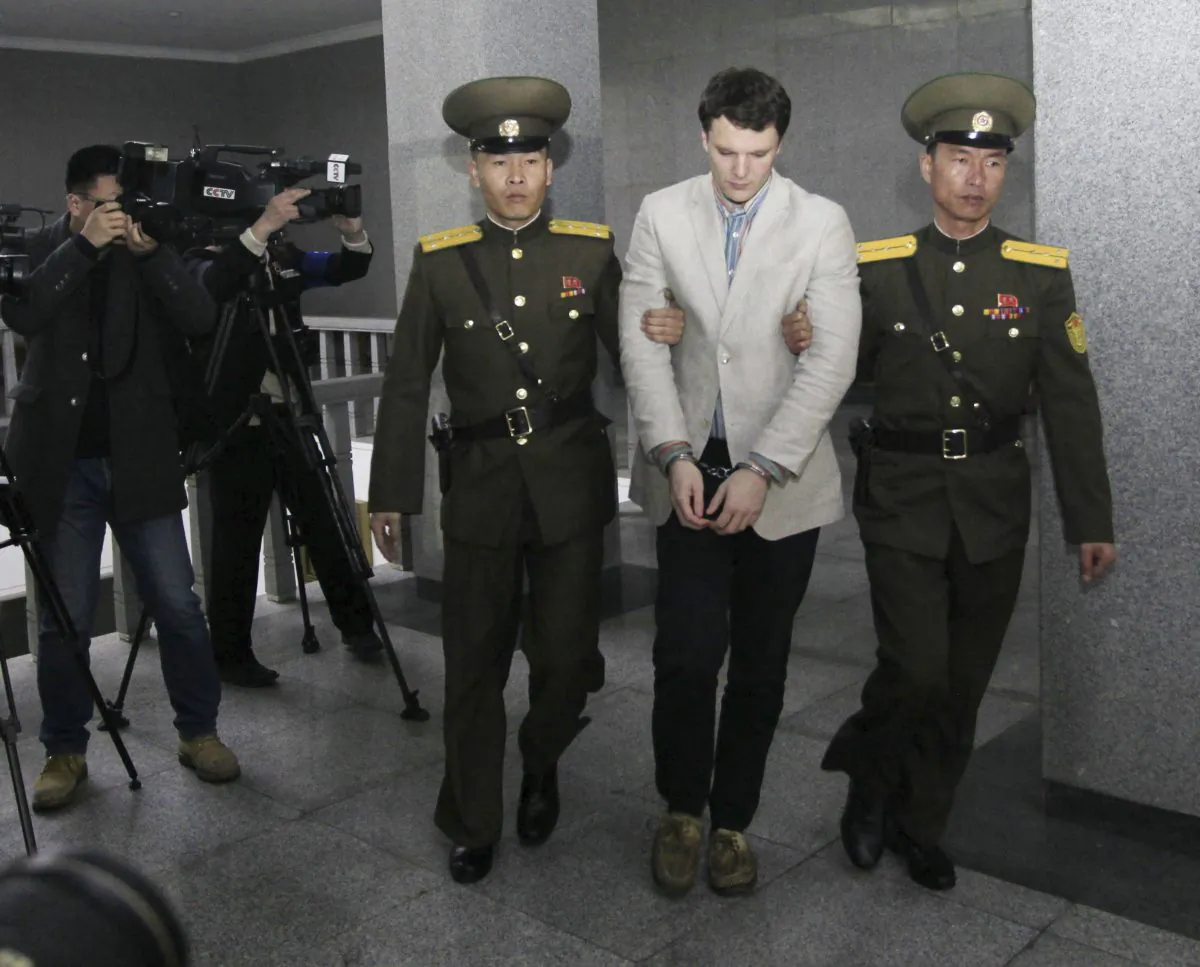 American student Otto Warmbier, center, is escorted at the Supreme Court in Pyongyang, North Korea on March 16, 2016,. (AP Photo/Jon Chol Jin)