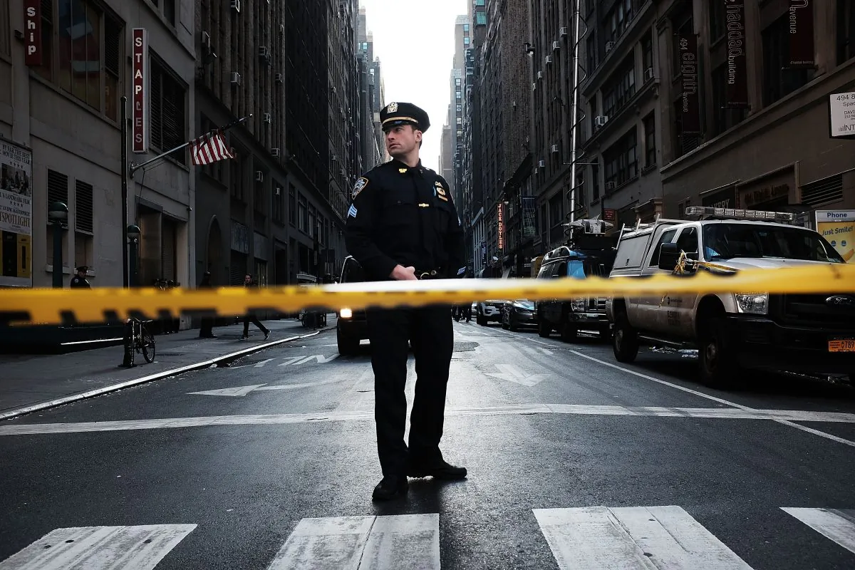 A police offficer stand at the scene of a midtown shooting that left one dead with two others wounded in New York City on Nov. 9, 2015. (Spencer Platt/Getty Images)