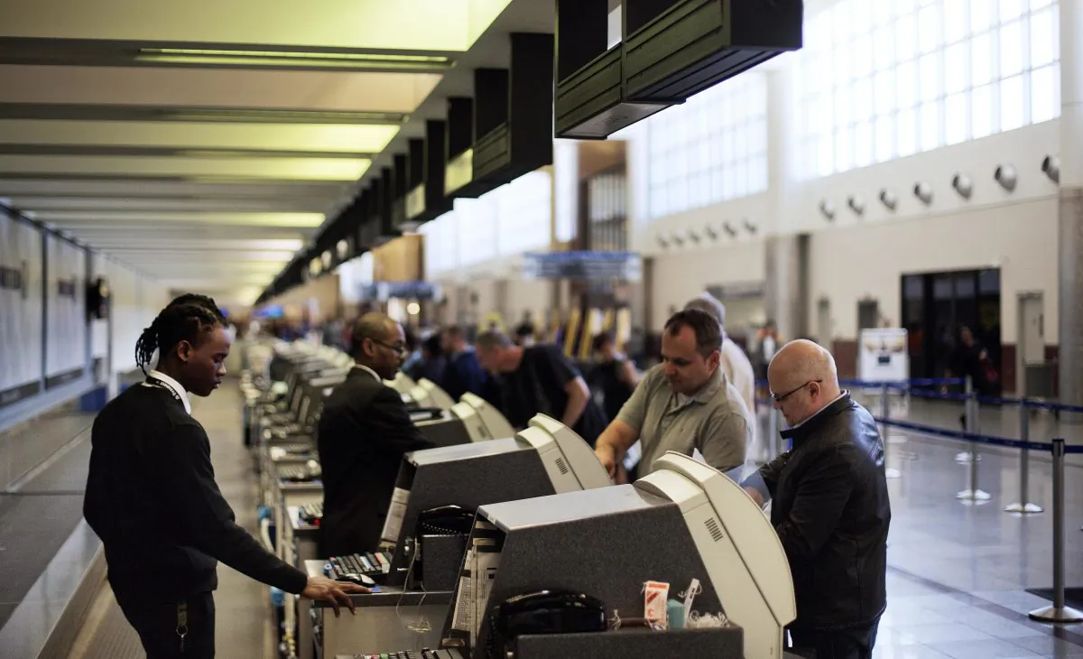 In this March 10, 2016 file photo, passengers check-in at the North terminal of the domestic passenger terminal at Hartsfield-Jackson Atlanta International Airport in Atlanta. Officials at Hartsfield-Jackson Atlanta International Airport this month said they were moving toward allowing Uber and other ride-sharing services, a reversal of a ban on such services from curbside pickup. (AP Photo/David Goldman)