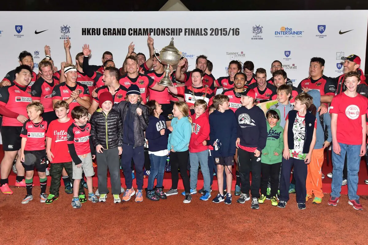 Societe Generale Valley together with young supporters celebrate defeating Leighton Asia HKCC 21-5 to win the HKRU Grand Championship final at King’s Park on Saturday March 12, 2016. (Bill Cox/Epoch Times)