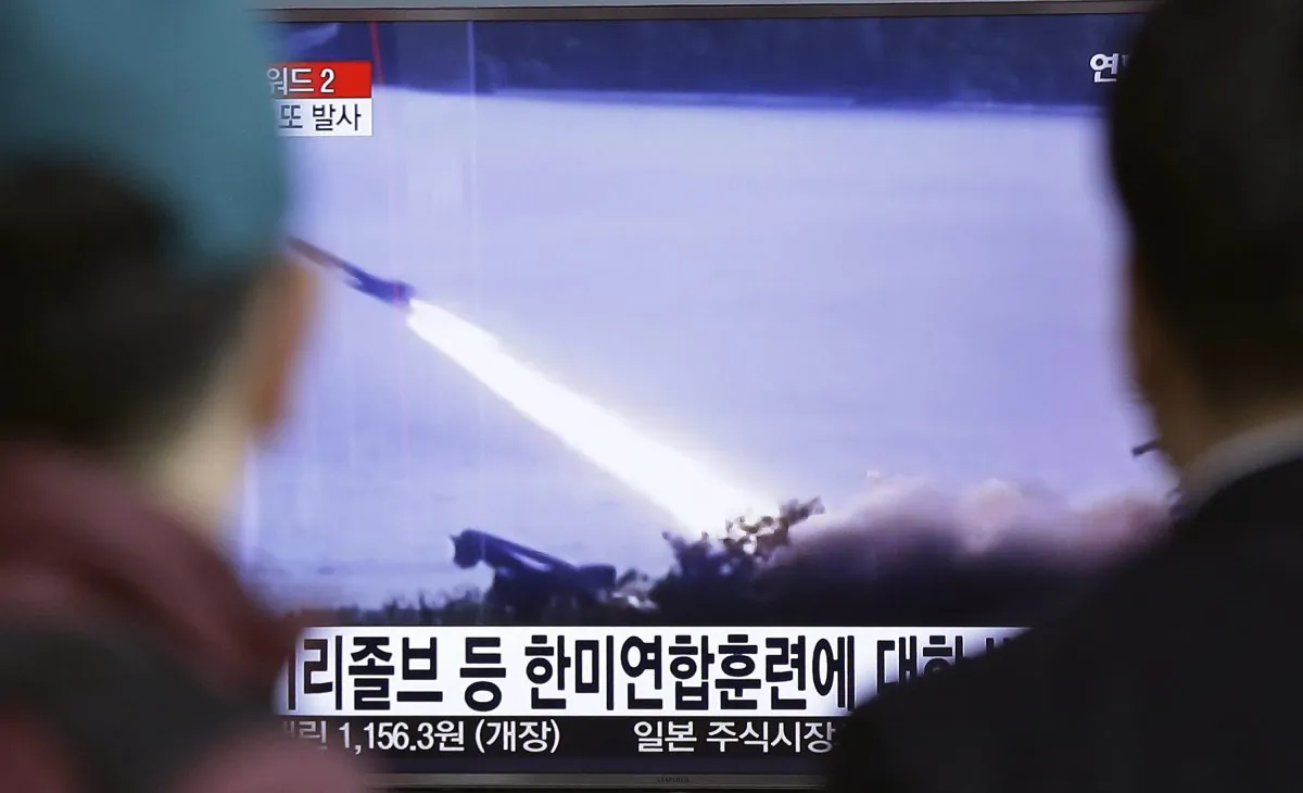 People watch a TV screen showing a file footage of a missile launch conducted by North Korea, at Seoul Railway Station in Seoul, South Korea, Friday, March 18, 2016. North Korea defied U.N. resolutions by firing a medium-range ballistic missile into the sea on Friday, Seoul and Washington officials said, days after its leader Kim Jong Un ordered weapons tests linked to its pursuit of a long-range nuclear missile capable of reaching the U.S. mainland. The letters on the screen read " North Korea fired a missile against the ongoing joint military exercises,dubbed Key Resolve and Foal Eagle, between South Korea and the United States.: (AP Photo/Ahn Young-joon)