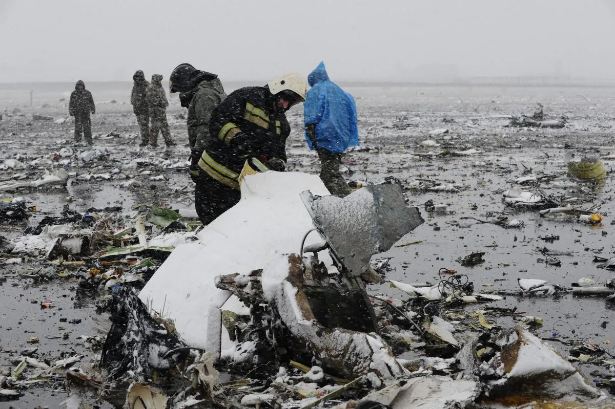 Russian Emergency Ministry employees investigate the wreckage of a crashed plane at the Rostov-on-Don airport, about 950 kilometers (600 miles) south of Moscow, Russia Saturday, March 19, 2016. A Dubai airliner crashed and caught fire early Saturday while landing in strong winds in the southern Russian city of Rostov-on-Don, officials said. (AP Photo)
