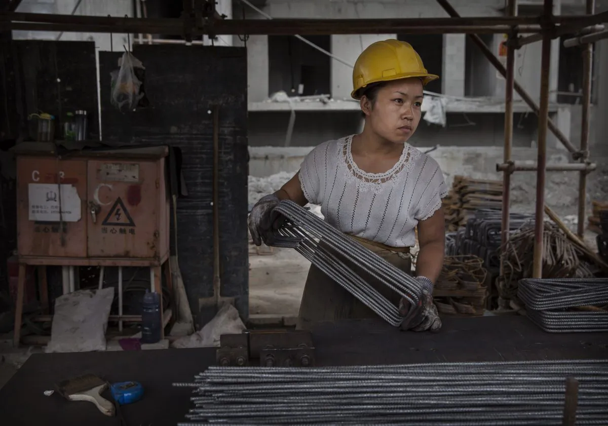 A Chinese female construction worker works at the building site of a new apartment complex in Beijing on Aug. 29, 2014. (Kevin Frayer/Getty Images)