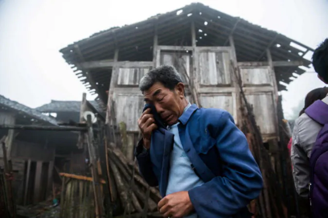 An elderly man crying in front of a damaged house in a remote village in the earthquake-affected Ya'an region of southwest China on April 23, 2013. (STR/AFP/Getty Images)