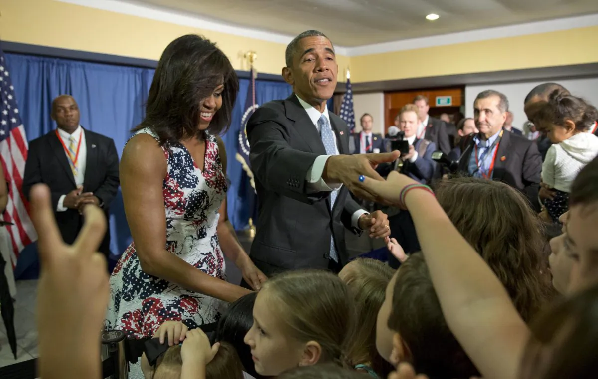 President Barack Obama, center, first lady Michelle Obama greet children and families of Embassy personnel during an event at Melia Habana Hotel, in Havana, Cuba, Sunday, March 20, 2016. (AP Photo/Pablo Martinez Monsivais)