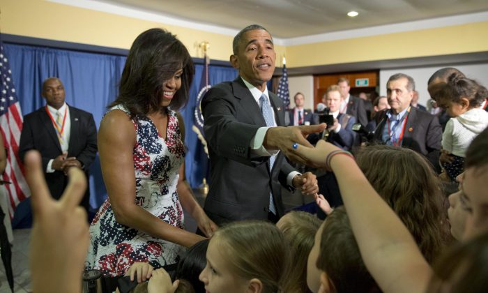 President Barack Obama, center, first lady Michelle Obama greet children and families of Embassy personnel during an event at Melia Habana Hotel, in Havana, Cuba, Sunday, March 20, 2016. (AP Photo/Pablo Martinez Monsivais)