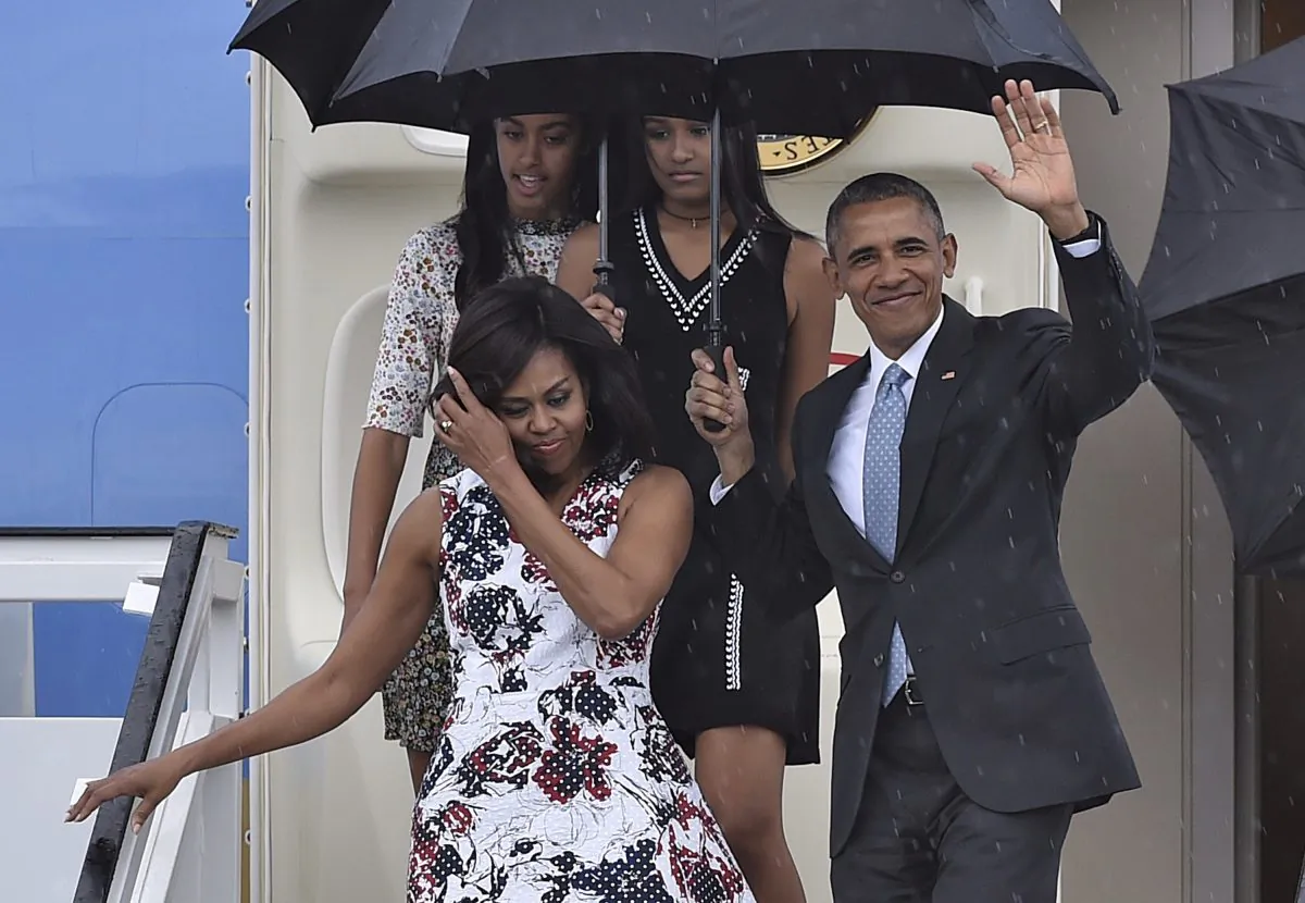 US President Barack Obama waves next to First Lady Michelle Obama (L) and their daughters Malia (L, behind) and Sasha upon their arrival at Jose Marti international airport in Havana on March 20, 2016. (Yuri Cortez/AFP/Getty Images)