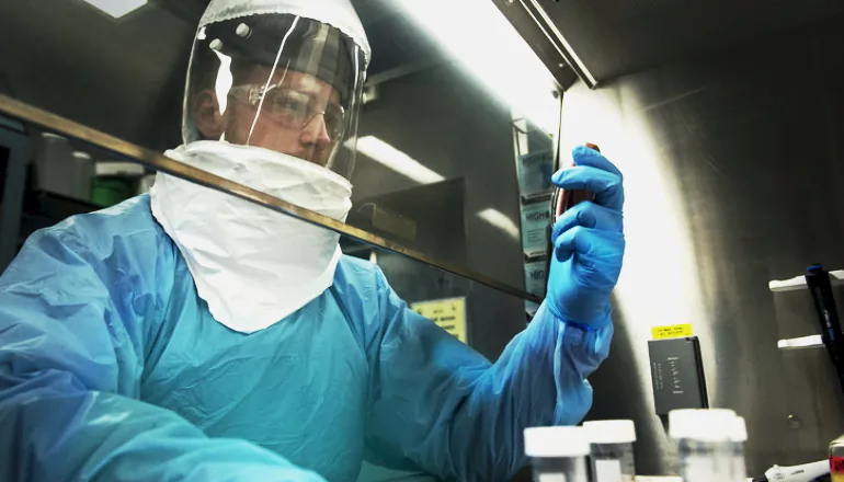 Tyler Goralski, a graduate student studying biochemistry and molecular biology at Penn State, streaks out a bacteria sample at the Pell Laboratory for Advanced Biological Research. (Patrick Mansell/Penn State)