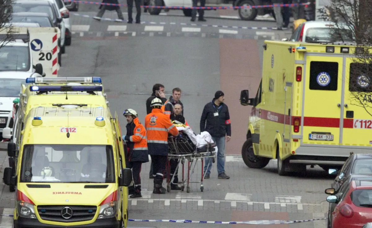 Emergency services evacuate a victim by stretcher after a explosion in a main metro station in Brussels on Tuesday, March 22, 2016. (AP Photo/Virginia Mayo)