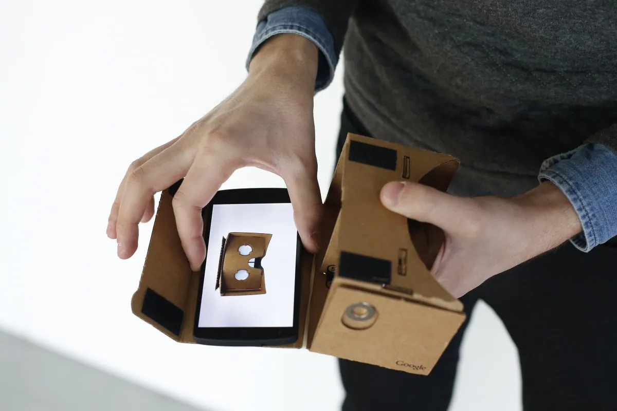 A Google employee presents a Google Cardboard virtual reality headset for android smartphones during a Google promotion event at the City of Fashion and Design (Cite de la mode et du design) in Paris on November 4, 2014. AFP PHOTO / THOMAS SAMSON (Photo credit should read THOMAS SAMSON/AFP/Getty Images)