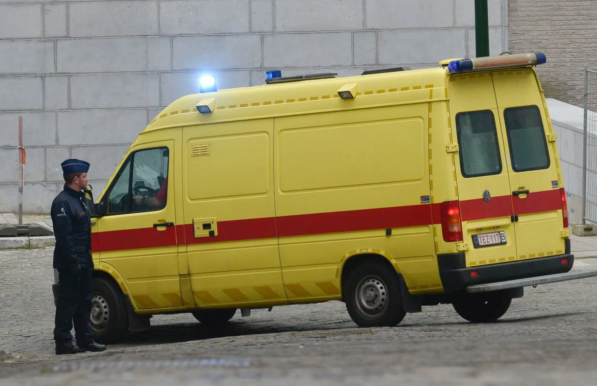 An ambulance believed to be transporting top Paris attacks suspect Salah Abdeslam leaves the building of the Federal Police in Brussels, on March 19, 2016.  (JOHN THYS/AFP/Getty Images)