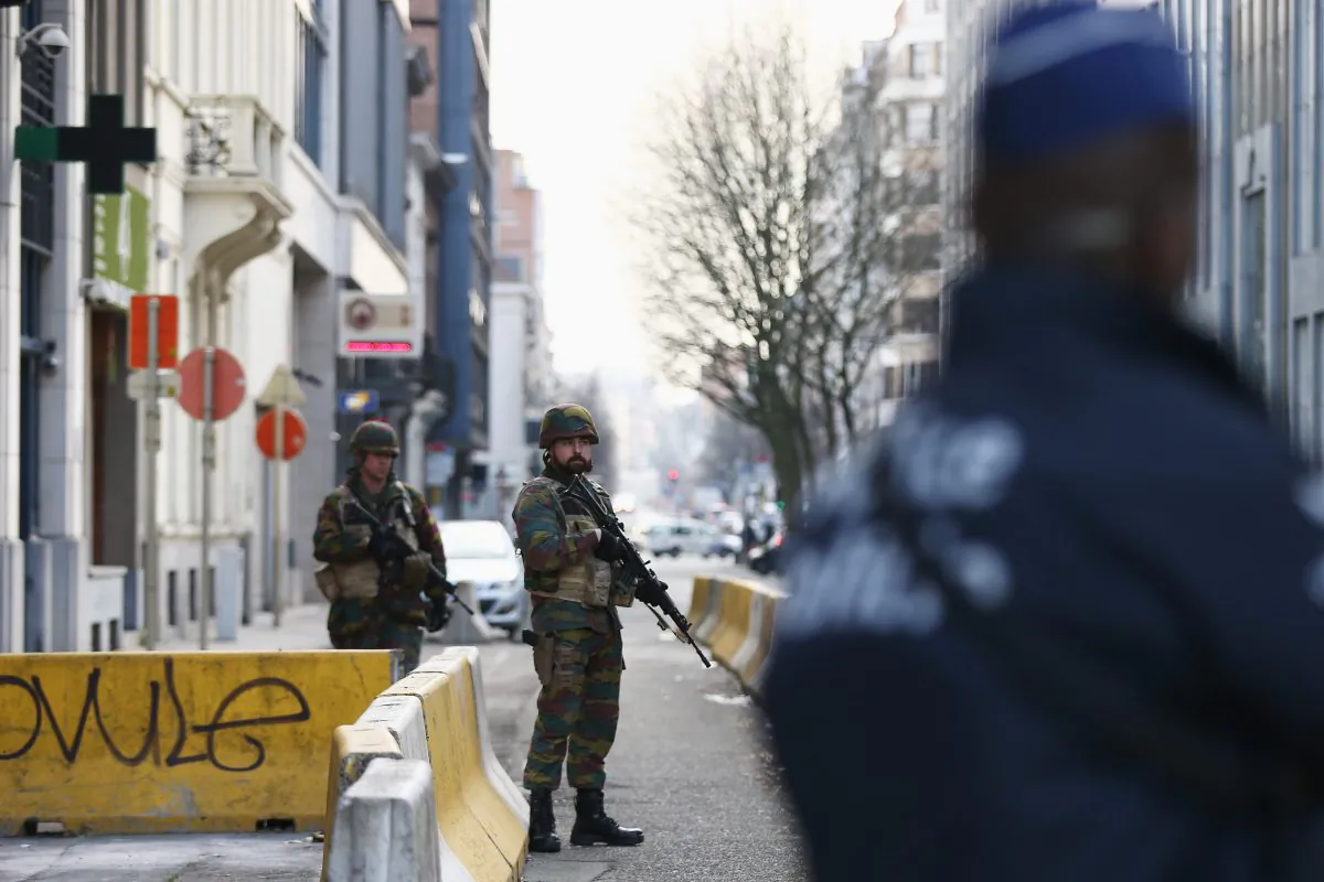 BRUSSELS, BELGIUM - MARCH 22: Soldiers and police officers stand guard outside EU Commission Headquarters following todays attack on March 22, 2016 in Brussels, Belgium. At least 34 people are thought to have been killed after Brussels airport and a Metro station were targeted by explosions. The attacks come just days after a key suspect in the Paris attacks, Salah Abdeslam, was captured in Brussels. (Photo by Carl Court/Getty Images)