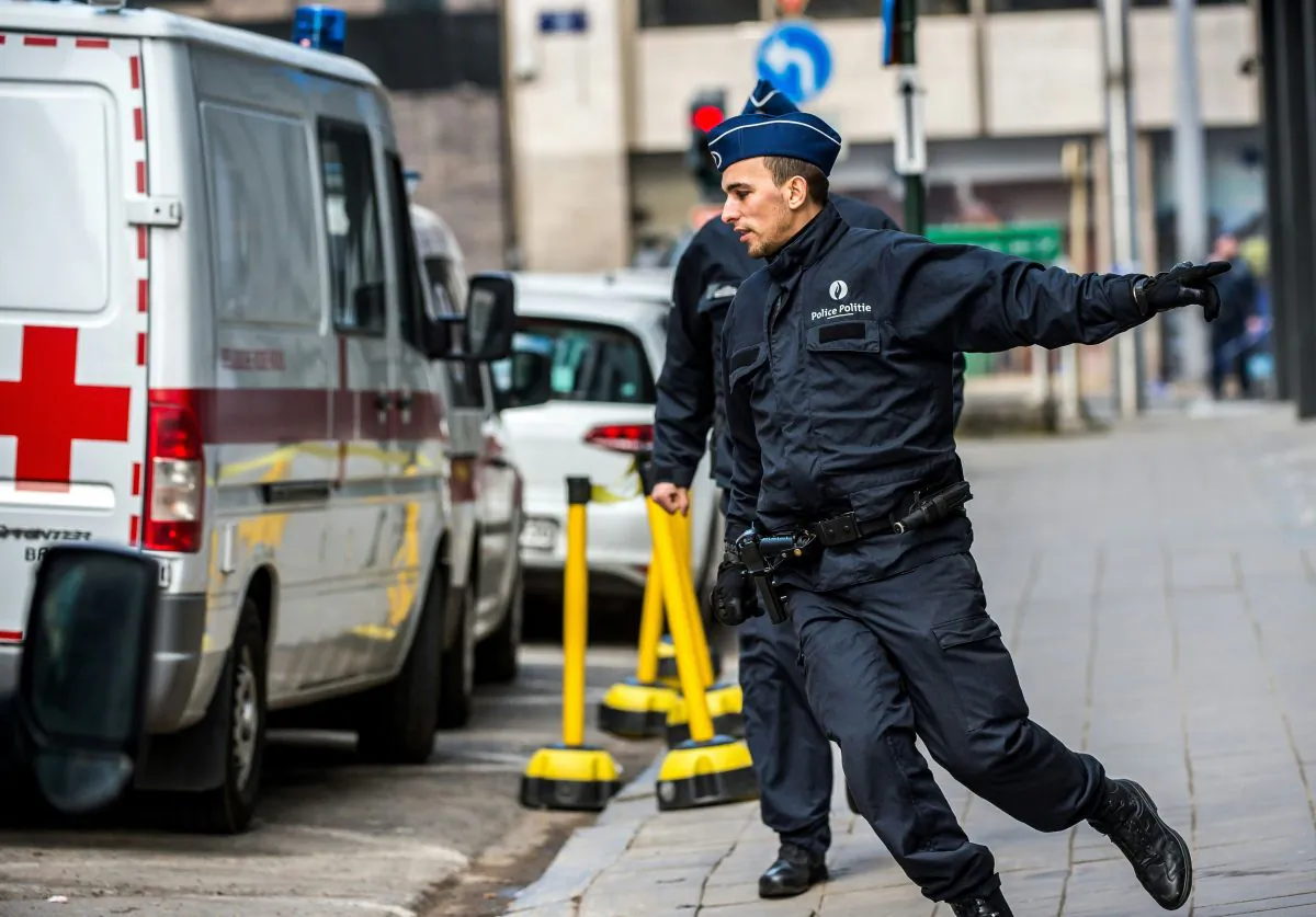 Police officers run towards Maalbeek metro station in Brussels on March 22, 2016 after a series of apparently coordinated explosions ripped through Brussels airport and a metro train. (Philippe Huegen/AFP/Getty Images)