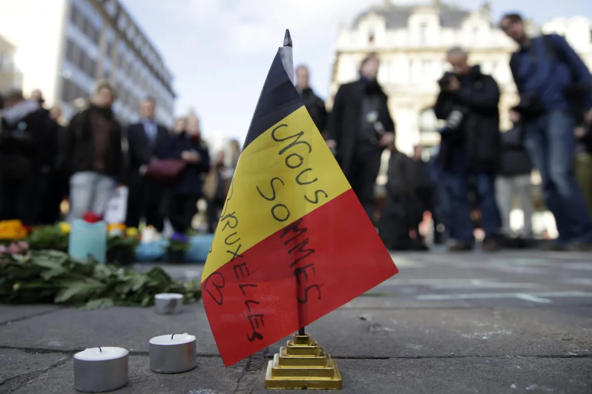 A Belgian flag reading "We are all Brussels" stands at a makeshift memorial at Place de la Bourse (Beursplein) following attacks in Brussels on March 22, 2016. (Kenzo Tribouillard/AFP/Getty Images)