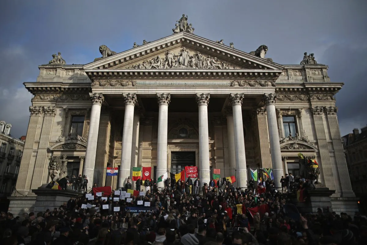 People chant and sing songs at the Place De La Bourse in honour of the victims of yesterdays' terror attacks, in Brussels, Belgium, on March 23, 2016. (Christopher Furlong/Getty Images)
