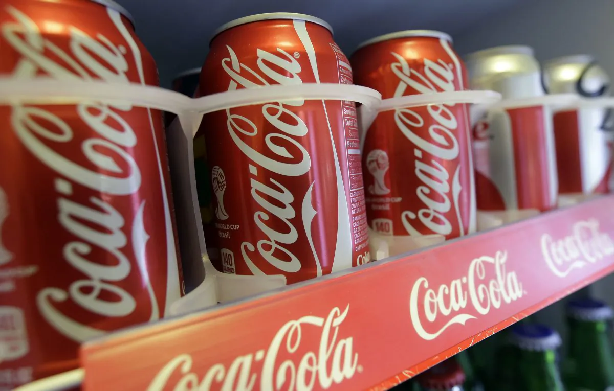 FILE - This June 30, 2014, file photo shows cans of Coca-Cola in the refrigerator of Chile Lindo in San Francisco. On Thursday, March 24, 2016, Coke said it spent more on health research and partnerships than it previously disclosed as part of its push to be more transparent. The world's biggest beverage company first disclosed its spending on various health-related efforts in the U.S. after coming under fire for its funding of the Global Energy Balance Network, a group that said its mission was to fight obesity. That group has since disbanded. (AP Photo/Jeff Chiu, File)
