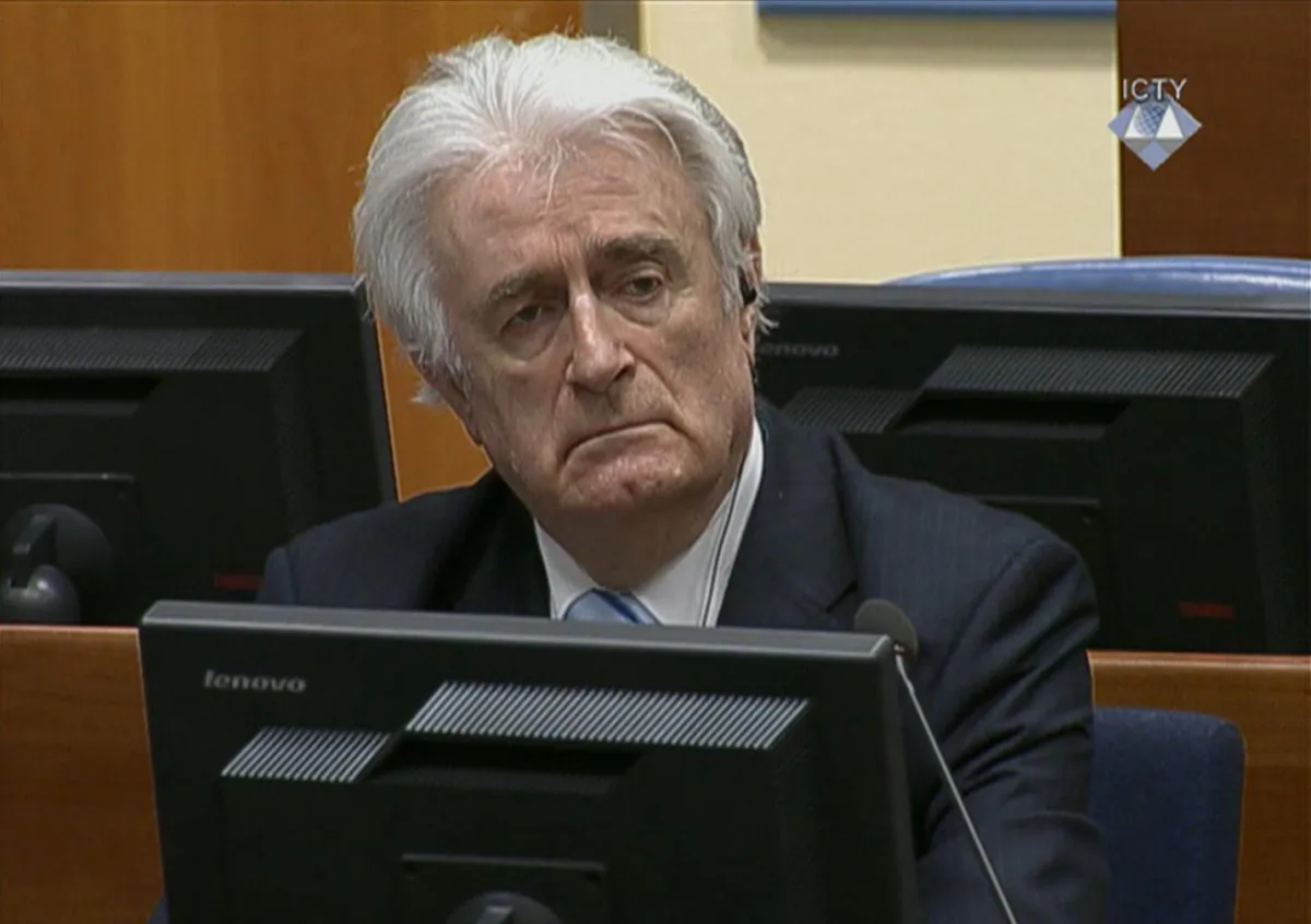 In this image taken from video Bosnian Serb wartime leader Radovan Karadzic listens to his sentence  at the International Criminal Tribunal for Former Yugoslavia (ICTY) in The Hague, The Netherlands Thursday March 24, 2016. Karadzic was convicted of genocide and nine other charges Thursday at a U.N. court, and sentenced to 40 years in prison. (ICTY, Pool via AP)