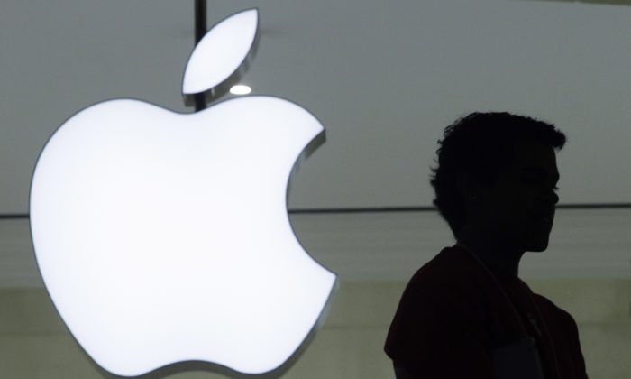 Dec. 7, 2011, file photo, a person stands near the Apple logo at the company's store in Grand Central Terminal, in New York. (AP Photo/Mark Lennihan, File)