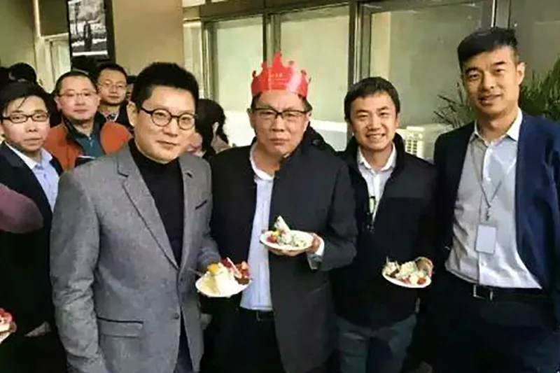 Ren Zhiqiang wearing a birthday hat, holding a cake at his 65 birthday party on March 8, 2016. (Internet image)