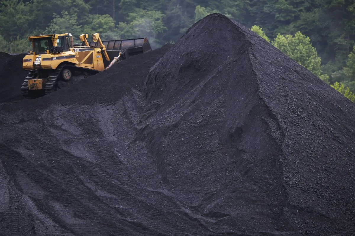 A bulldozer operates atop a coal mound at the CCI Energy Slones Branch Terminal in Shelbiana, Ky., on June 3, 2014. (Luke Sharrett/Getty Images)