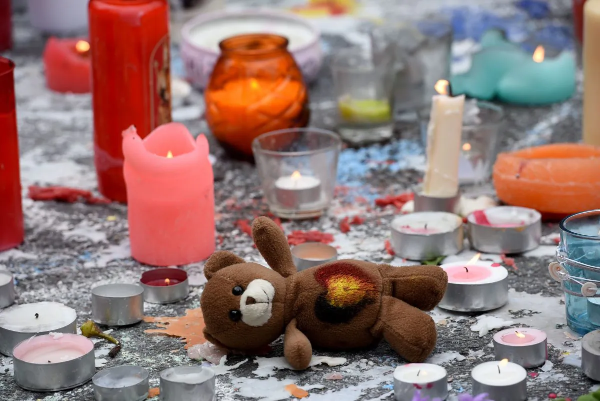 A teddy bear layed next to candles as people gather to observe a minute of silence in memory of the victims of the Brussels airport and metro bombings, on the Place de la Bourse in central Brussels on March 23, 2016, a day after the triple blasts killed more than 30 people and left other 300 injured. (Patrick Stollarz/AFP/Getty Images)