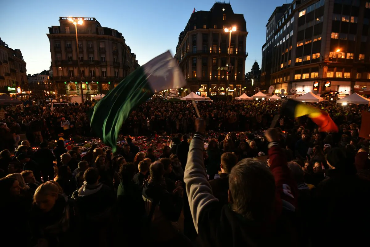 People gather to pay tribute to the victims of the Brussels attacks on the Place de la Bourse (Beursplein) in central Brussels, on March 25, 2016, three days after a triple bomb attack, which responsibility was claimed by the Islamic State more than 30 people and wounding 300 others. (Patrick Stollarz/AFP/Getty Images)
