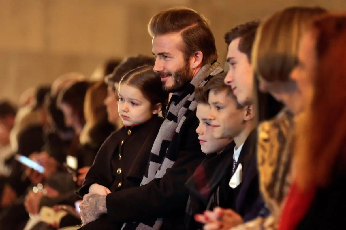 David Beckham and his three sons wait for the the Victoria Beckham Fall 2016 collection to be modeled during Fashion Week in New York, Feb. 14, 2016. (AP Photo/Richard Drew)