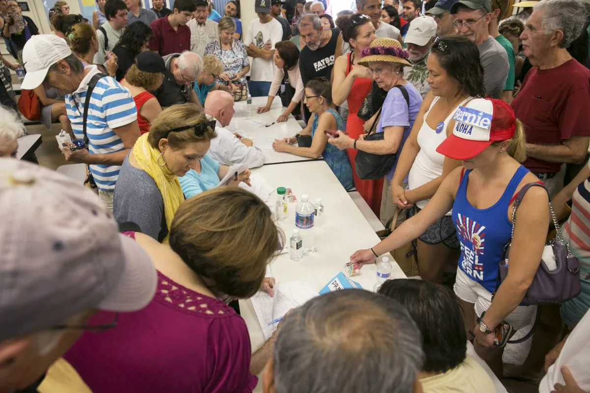 Voters crowd the voting tables during the Hawaii caucus at Kailua Intermediary School in Kailua, Hawaii, on March 26, 2016. (Marco Garcia/AP Photo)