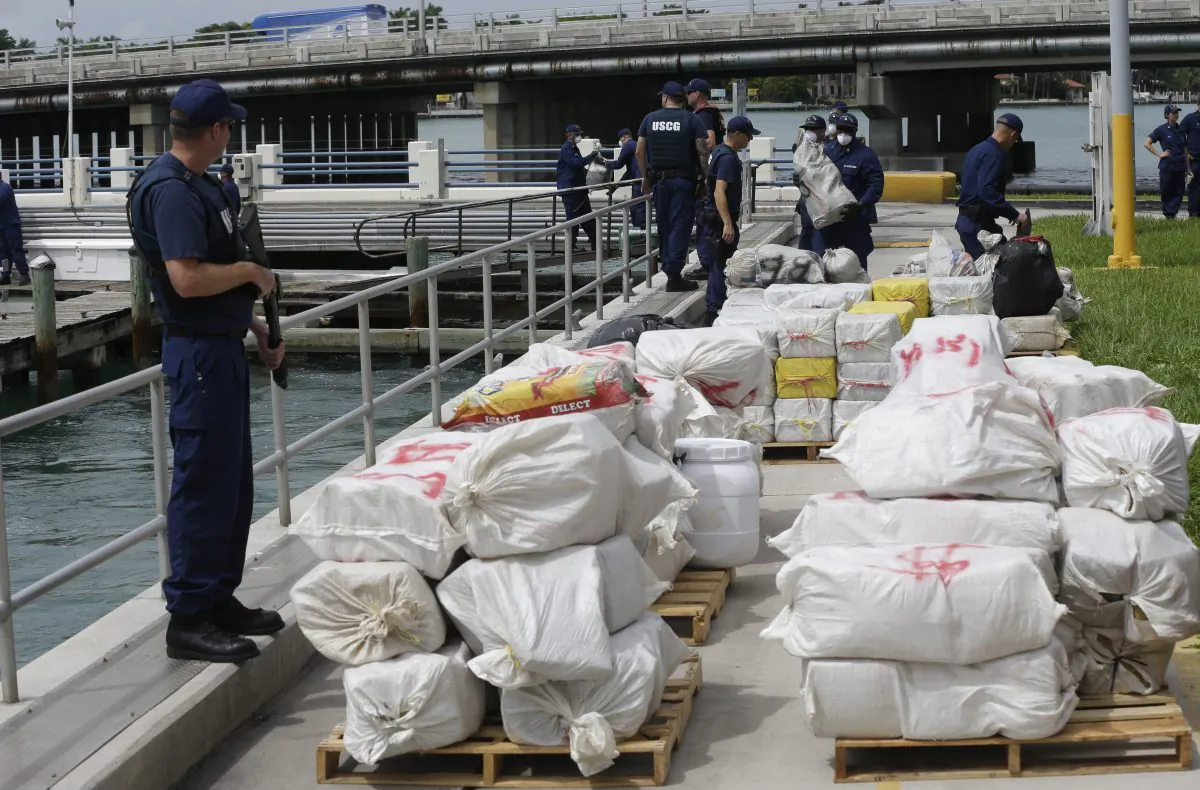 A U.S. Coast guardsman stands guard over bales of cocaine and marijuana as part of an estimated $41 million worth of drugs at the Coast Guard Base Miami Beach, Tuesday, Sept. 29, 2015, in Miami Beach, Fla.  (AP Photo/Lynne Sladky)