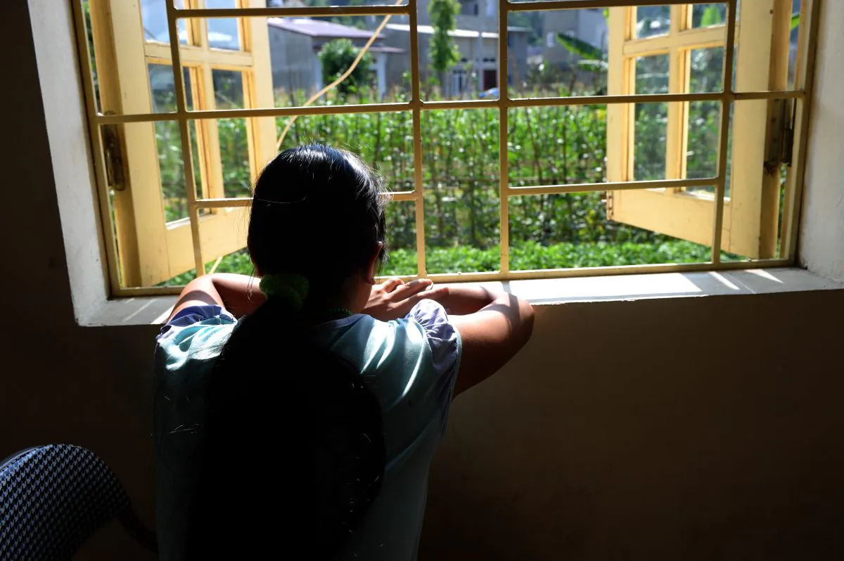 H'mong ethnic girl Kiab (a pseudonym to protect her identity) looks out a window at a center for trafficked women in the northern city of Lao Cai on May 9, 2014. When Kiab turned 16, her brother promised to take her to a party in a tourist town in northern Vietnam. Instead, he sold her to a Chinese family as a bride. (Hoang Dinh Nam/AFP/Getty Images)