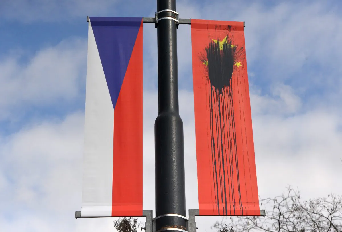 A Czech National flag hangs next to a Chinese National flag splattered with a black substance in Prague on March 26, 2016. (MICHAL CIZEK/AFP/Getty Images)