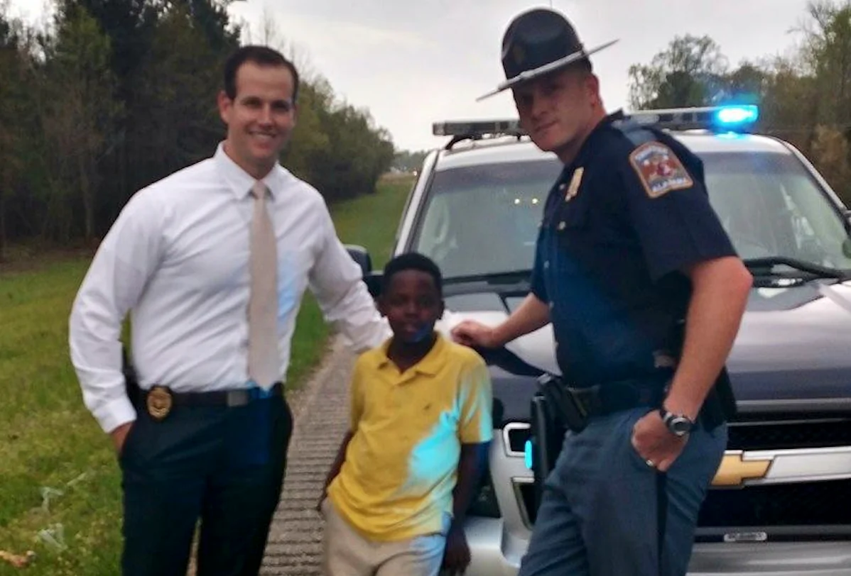 Third-grade student Christopher Wheeler with a police officer (Alabama Law Enforcement Agency)