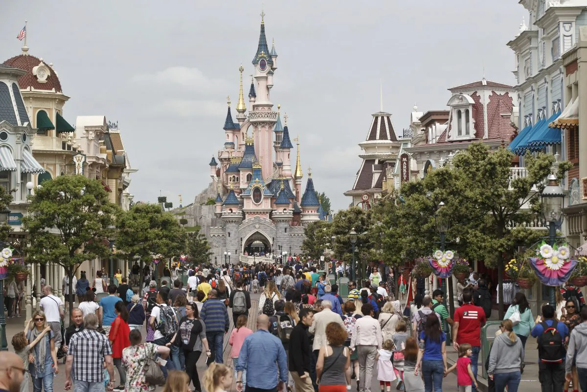 Visitors walk near Sleeping Beauty's Castle at Disneyland during happier times. (AP Photo/Michel Euler)