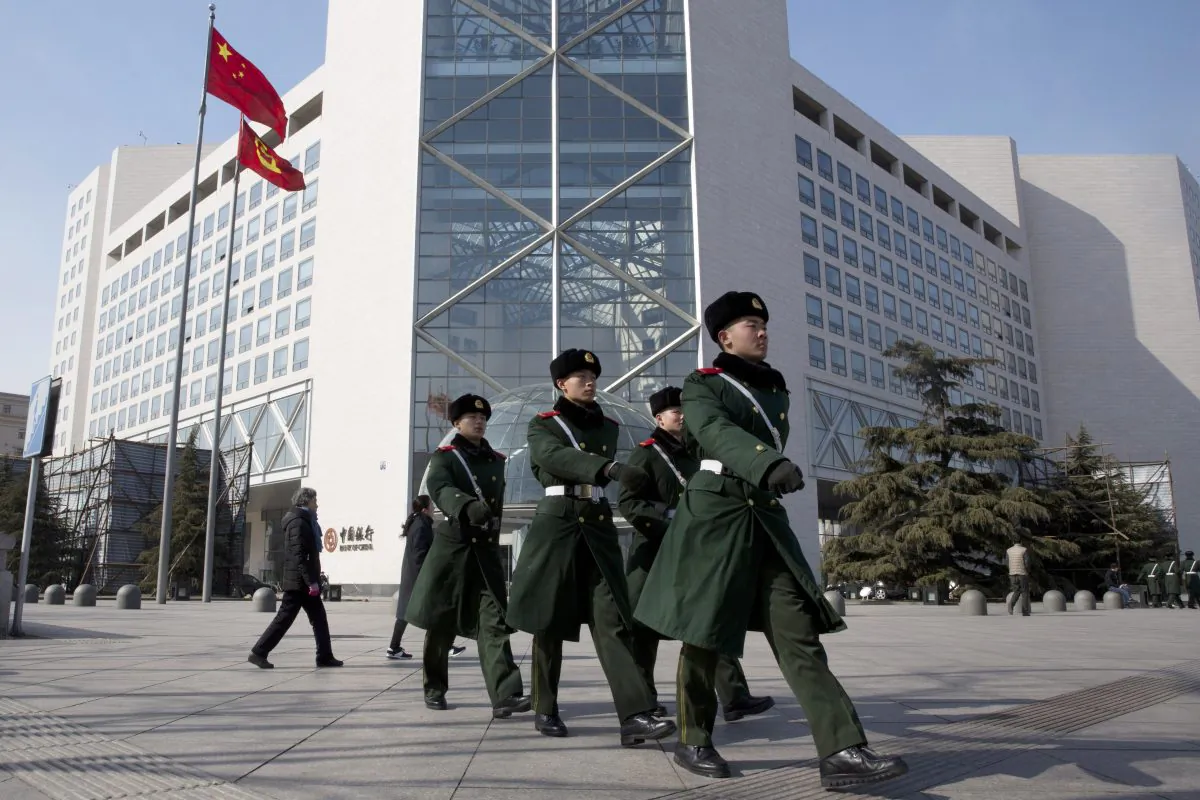 Chinese paramilitary policemen march outside the Bank of China headquarters in Beijing, China, on Feb. 25, 2016.  (AP Photo/Ng Han Guan)