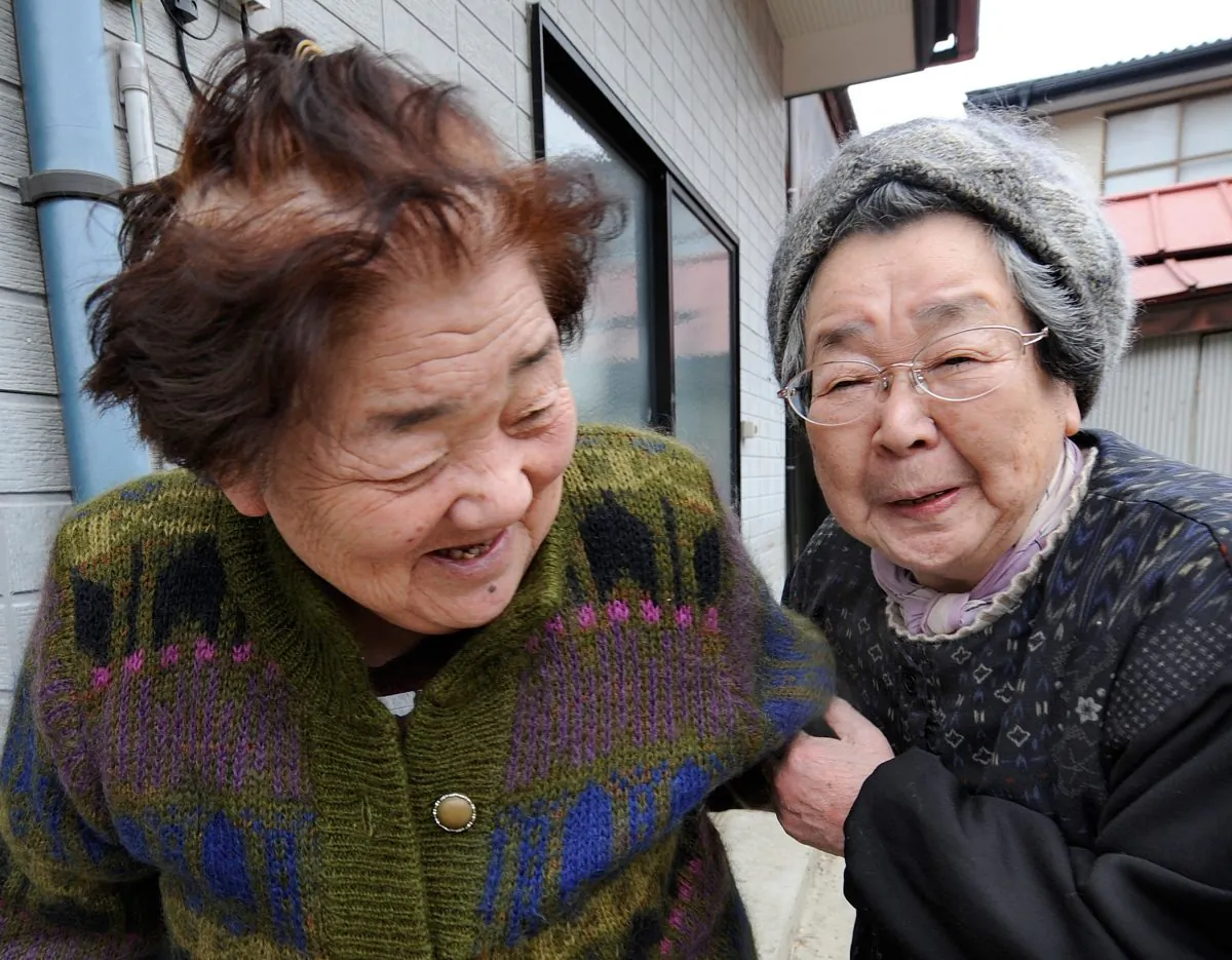Two elderly survivors and friends smile as they are reunited 10 days after the massive 9.0 earthquake and tsunami in Ishinomaki, Miyagi Prefecture, on March 21, 2011. (Toru Yamanaka/AFP/Getty Images)