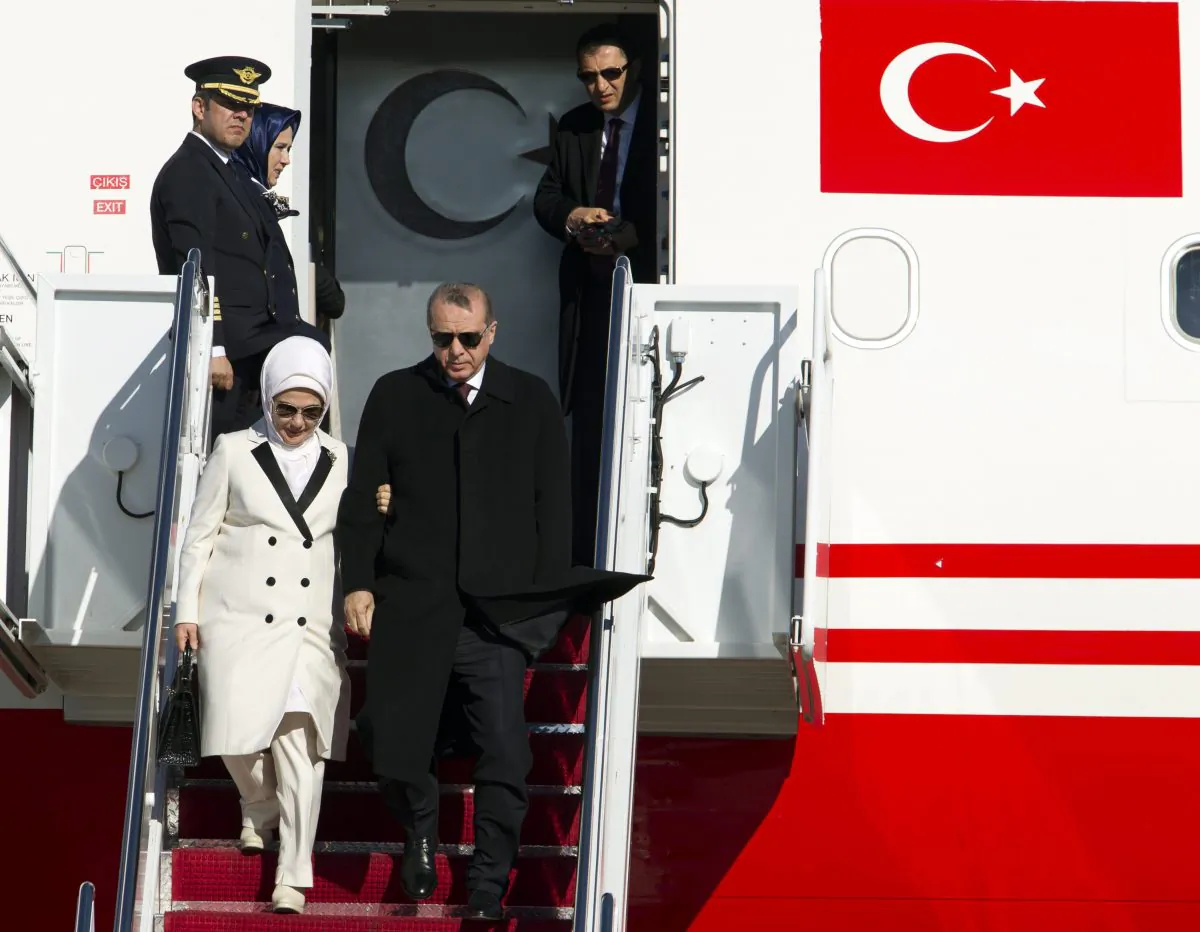 Turkish President Recep Tayyip Erdogan and his wife Emine disembark from a plane upon at Andrews Air Force Base, Md., on March 29, 2016. Erdogan is in Washington to attend the Nuclear Security Summit, along with other world leaders. (AP Photo/Jose Luis Magana)