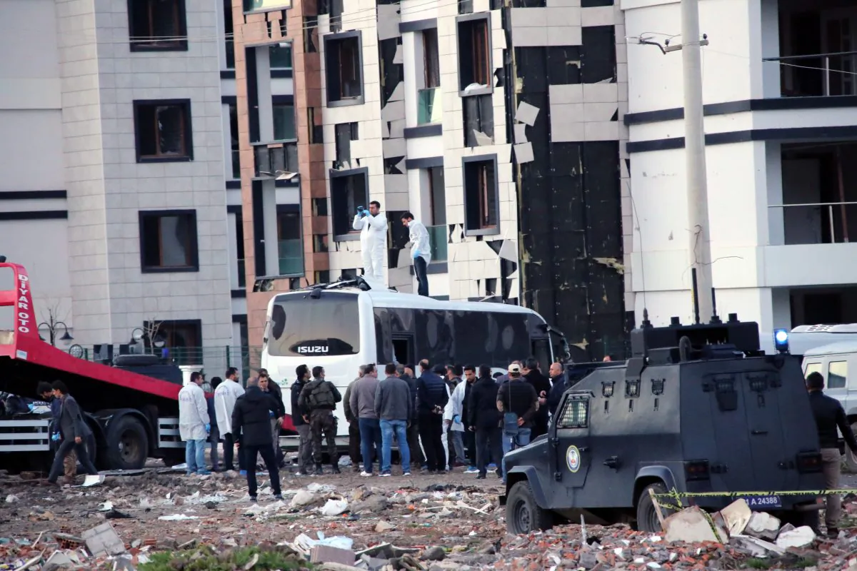 Security and forensic officers work at the site after an explosion caused by a bomb-laden car targeting police in the mainly Kurdish city of Diyarbakir, Turkey, Thursday, March 31, 2016, Turkish news agencies reported. (AP Photo/Mahmut Bozarslan)