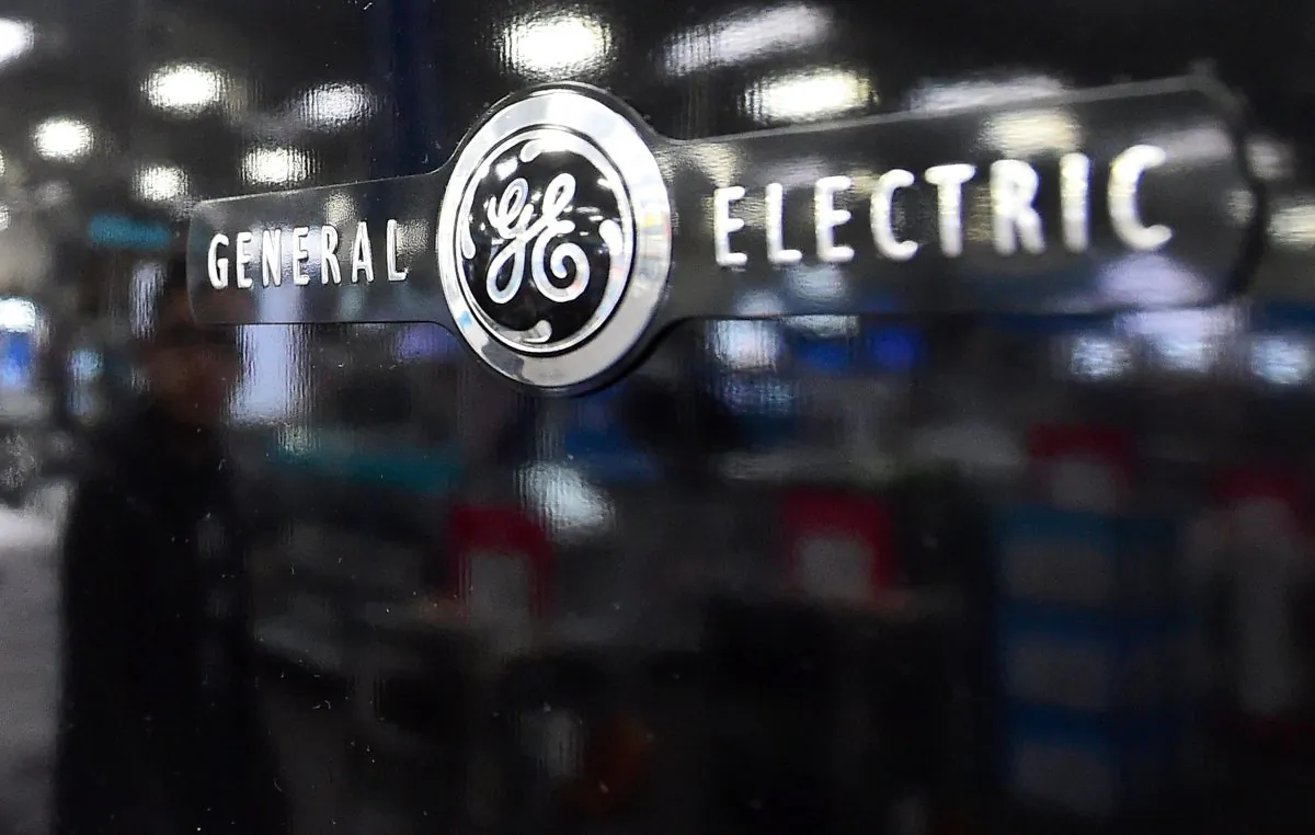 A reflection on the black door of a General Electric refrigerator at a store selling electronics and appliances in Montebello, Calif., on Jan. 15, 2016. (Frederic J. Brown/AFP/Getty Images)