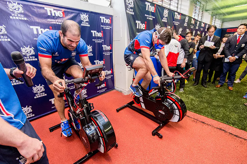 Thomas Lamboley (L) and Dan Falvey working their way through exercises involving sophisticated power bikes which measure performance from oxygen intake to power output per leg at the opening of the Elite Rugby Training Centre (ETRC) on Monday March 21, 2016. (HKRFU) 